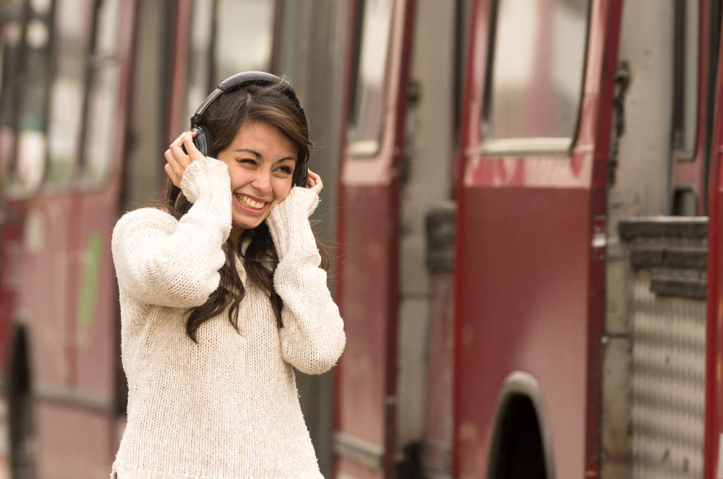 woman wearing noise cancelling headphones amidst heavy traffic